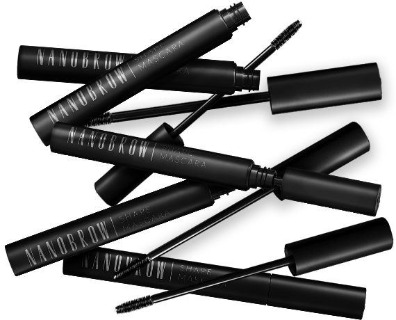 Black mascara tubes and brushes on dark background