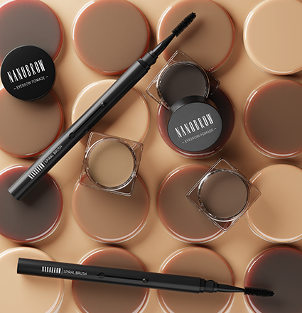 Eyebrow styling brush and brow pomade jars on beige background