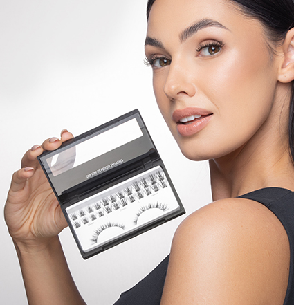 Blonde woman holding eyelash extension kits