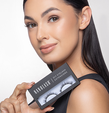 Blonde woman holding eyelash extension kits