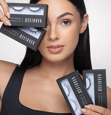 Blonde woman holding eyelash extension kits