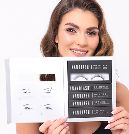 Model with  a wide smile holding a lash extensions starter kit