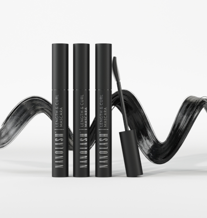 Three mascaras standing upright with a black paint streak in the background